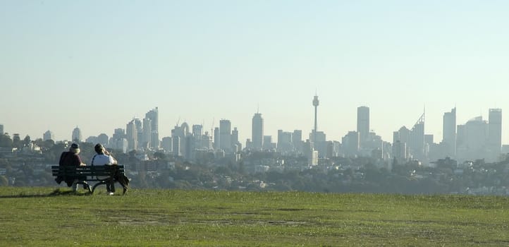 two young man relaxing in park and viewing sydney scenery