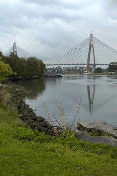 Anzac bridge in Sydney, lake and grass in foreground, 