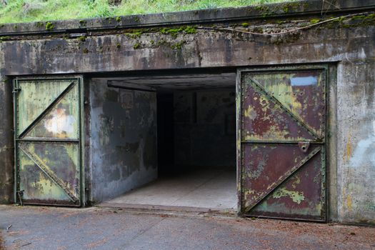 Rusted mossy steel door entrance to fort worden artillery bunker