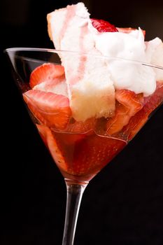 Strawberry shortcake in a martini glass sponge cake and whip cream