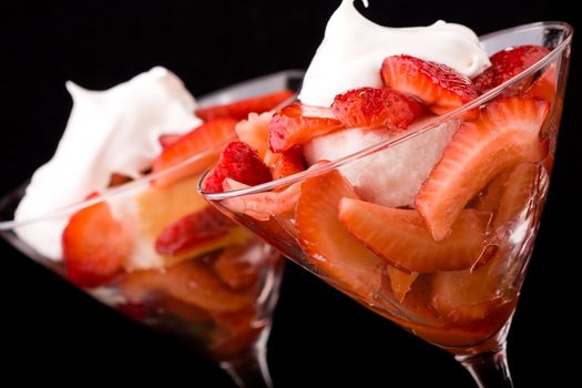 Strawberry shortcake in a martini glass sponge cake and whip cream