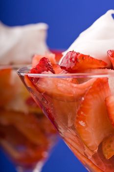 Strawberry shortcake in a martini glass sponge cake and whip cream