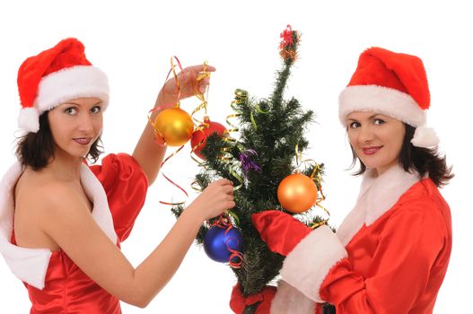 Two women santa decorate a christmas tree isolated on white background