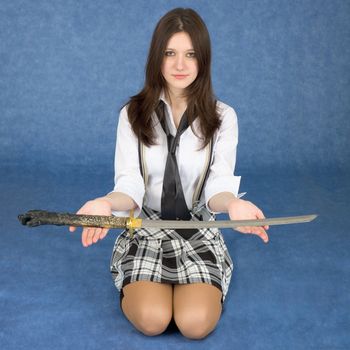 Young girl with sword sit on a blue background