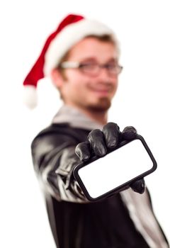 Smiling Young Man with Santa Hat Holding Out Blank Cell Phone Isolated on a White Background.