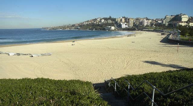 panorama of famous coogee beach in sydney, empty beach, small boats on left side
