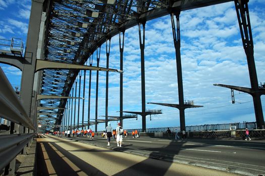 people walking empty harbour bridge on sydney marathon day