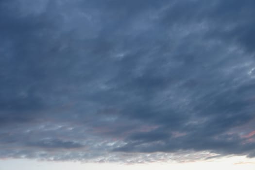 The cloudy evening dark sky over horizon