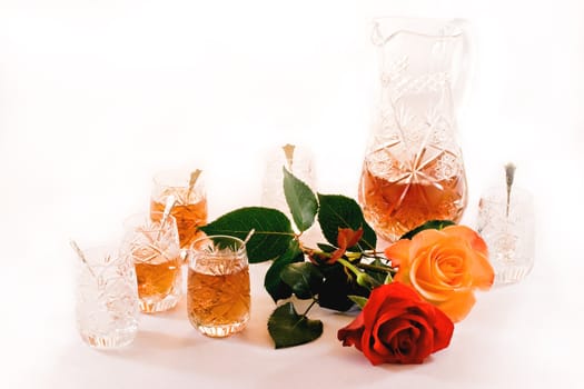 Turkish crystal teaset with can, tiny glasses and roses on white background