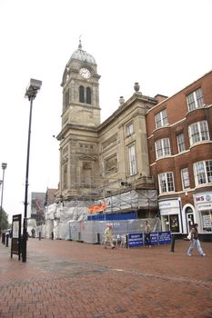 guildhall showing the clock and tower with the lower part surround by cover whilst restoration is taking place