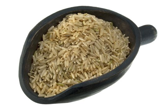 long grain brown rice on a rustic wooden scoop, isolated on white