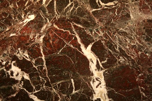 A red marble texture with white lines running through it.