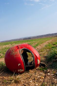Broken red helmet on the ground