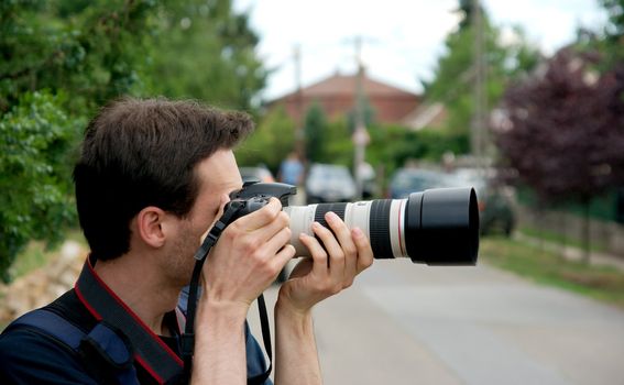 Photographer taking pictures with a telephoto lens