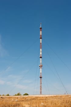 Tall communication tower on a barren land