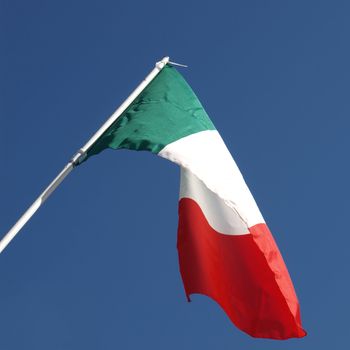 Flag of Italy over blue sky background