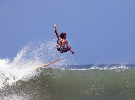 Young men - the surfer in ocean. Bali. Indonesia