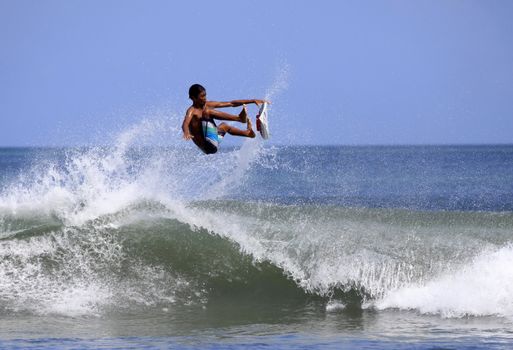 Young men - the surfer in ocean. Bali. Indonesia