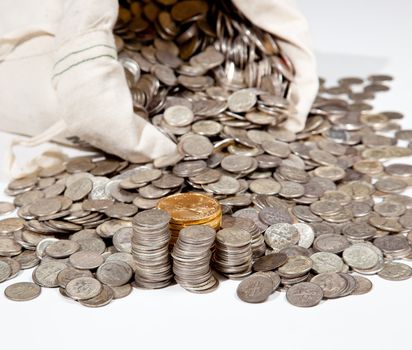 Linen bag of old pure silver coins used to invest in silver as a commodity with a selection of Golden Eagle gold coins