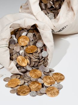 Linen bag of old pure silver coins used to invest in silver as a commodity with a selection of Golden Eagle gold coins