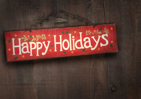 Holiday sign on distressed wooden wall