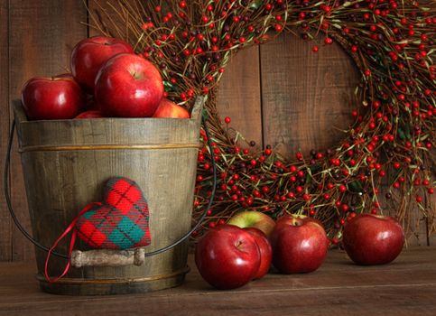 Red apples in wood bucket for holiday baking