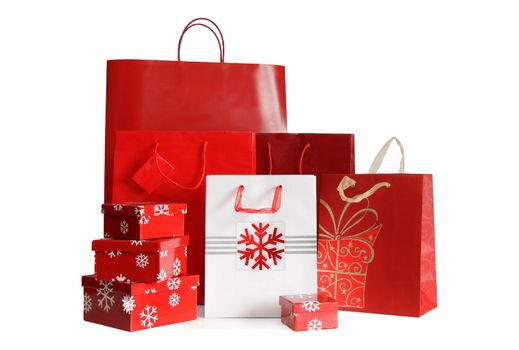 Various sizes of holiday shopping bags and gift boxes on white background