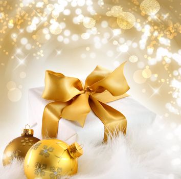 Gold ribboned gift with festive holiday background