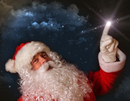 Santa pointing with magical light to the sky