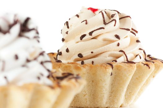 Macro view of cake with whipped cream isolated over white