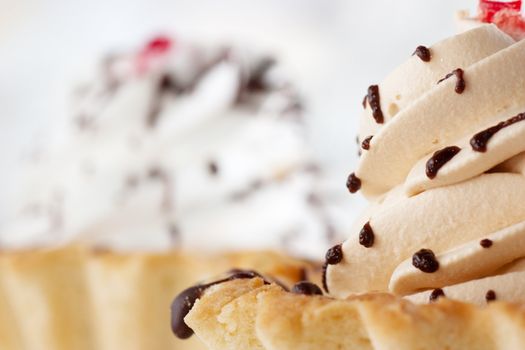 Macro view of cakes with whipped cream