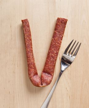 An image of a german sausage and a fork