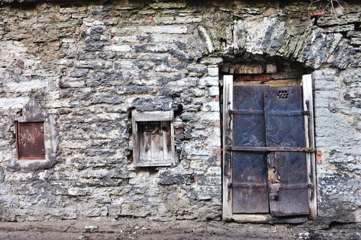 Closed windows on the ancient brick wall