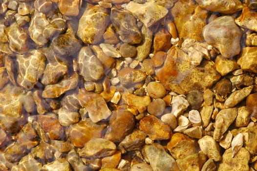 pebbles under flowing clear water