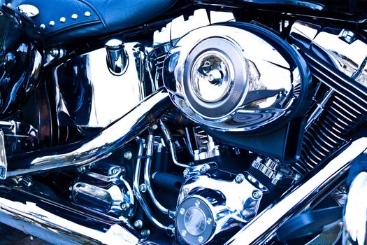 Side view of an engine of motorcycle, with blue tint.