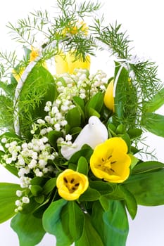 White basket full of tulips, with white pigeon and lilies of the valley.