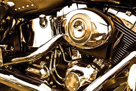 Side view of an engine of motorcycle in sepia.