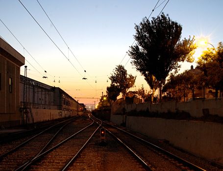 The railway station in Oeiras, Portugal, photographed at sunset from the tracks