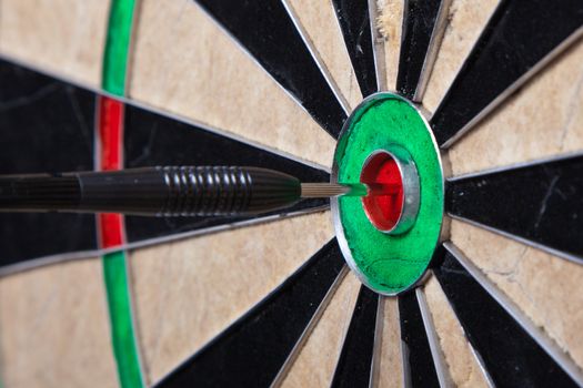 Closeup Image Of An Arrow Straight In The Center Of Darts Board