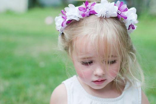 Little girl portrait with wreath, outdoor shooting