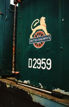 Cab of an abandoned engine bearing the logo of the defunct British Railways