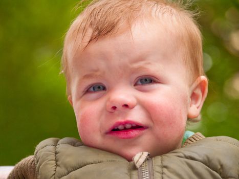 Happy baby boy looking shocked