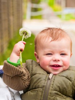 Baby boy showing off his  flower