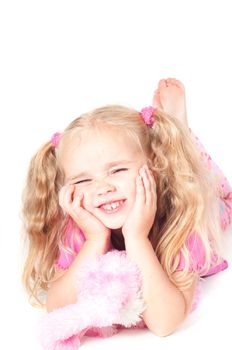 Little cute girl in pink and with ponytails in studio