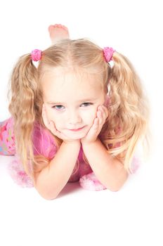 Little cute girl in pink and with ponytails in studio