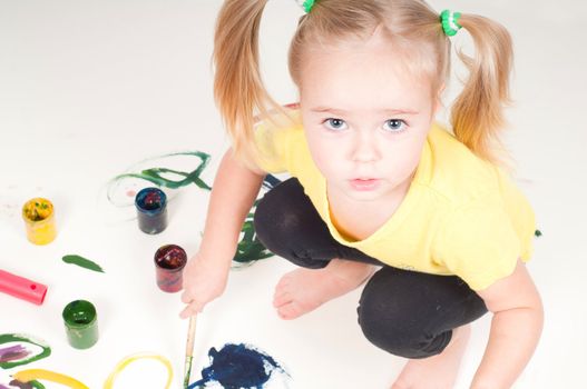 Shot of little girl who penting on the floor