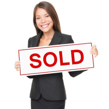 Real estate agent holding sold sign isolated on white background. Beautiful cheerful Asian / Caucasian female realtor smiling confident in black suit.