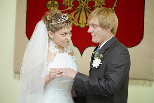 The young bride solemnly ringed the groom