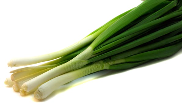 A bunch of fresh green onions (sometimes called shallots or scallions), isolated on white.