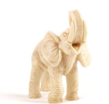 Small elephant model standing towards white background